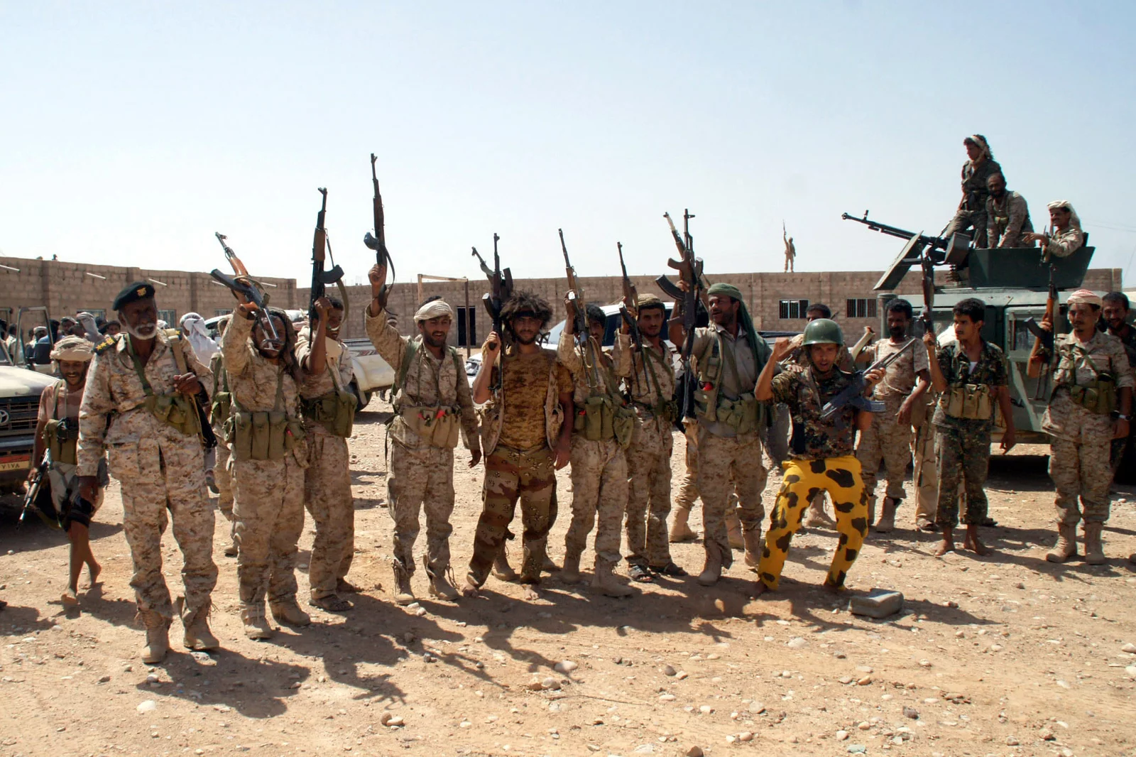 Yemeni soldiers hold up their weapons at an area seized from Al-Qaeda in the southeastern province of Shabwa, Yemen. (AP/File Photo)