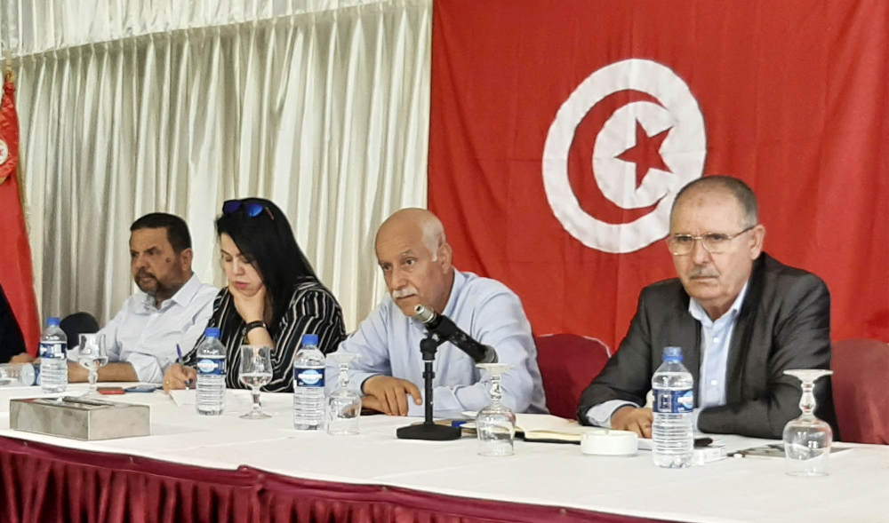 Noureddine Taboubi (R), Secretary-General of the Tunisian General Labour Union, chairs the meeting of the body's national administrative commission in Hammamet on May 23, 2022. (AFP)