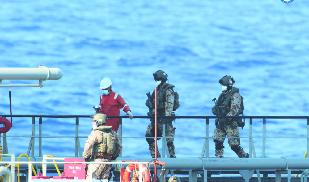 A boarding team inspects the merchant vessel Royal Diamond 7 in international waters, 150 km north of the Libyan city of Derna, on Sept. 10, 2020, as the EU maritime force enforced the UN arms embargo on Libya. (AP)