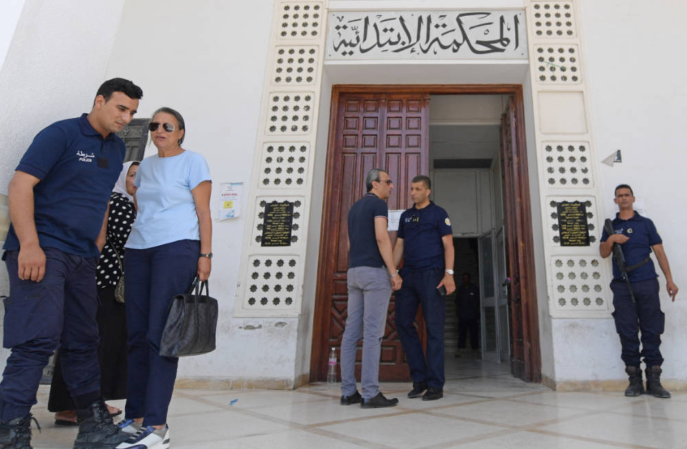 Police officers stand at the entrance to the Ariana tribunal near the Tunisian capital Tunis on June 6, 2022. (AFP)