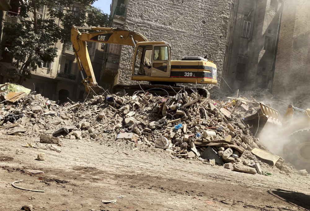 A bulldozer removes the debris following the collapse of a building  in Cairo on Friday. (AP)