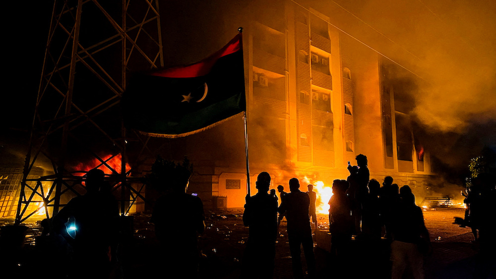 Protesters set fire to the Libyan parliament building after protests against the failure of the government in Tobruk, Libya July 1, 2022. (Reuters)