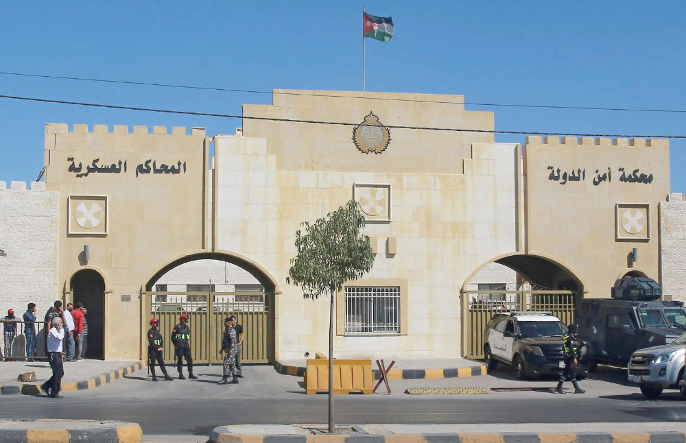 Policemen stand guard outside the State Security Court in the Jordanian capital Amman. (AFP)