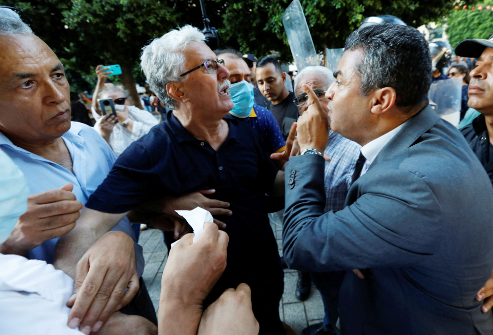 Hamma al-Hammami, a leftist activist and former political prisoner, confronts with police during a protest against the President Kais Saied's upcoming referendum in Tunis, Tunisia July 22, 2022. (REUTERS)