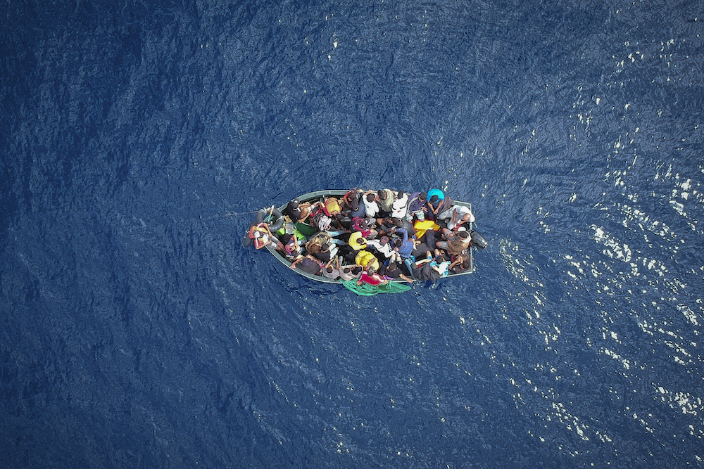 A boat carrying migrants stranded in the Strait of Gibraltar before being rescued by the Spanish Guardia Civil and the Salvamento Maritimo sea search and rescue agency. (AFP)