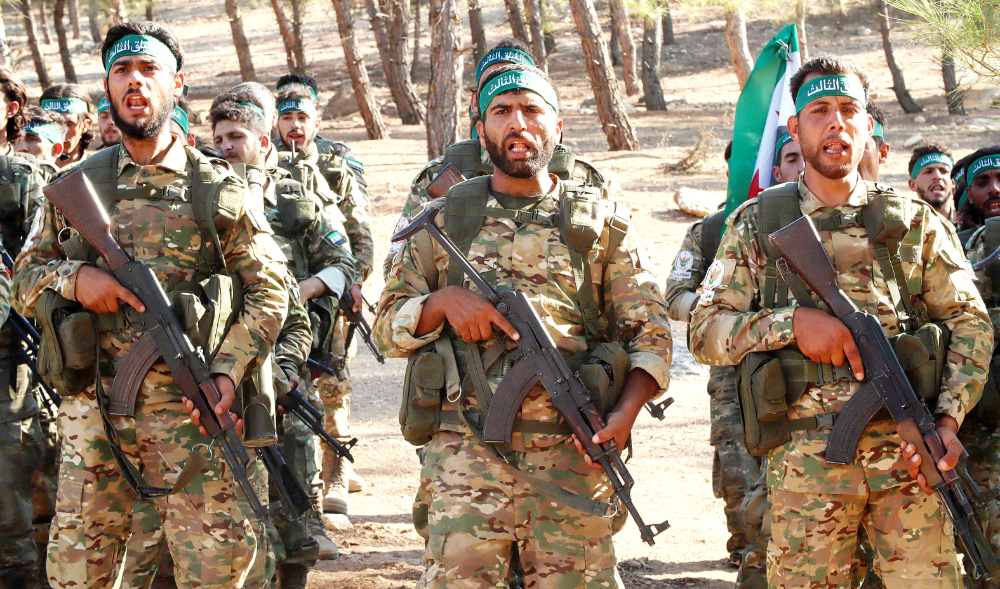 Fighters from the Free Syrian Army take part in a military training exercise near the border town of Azaz in the north of the Aleppo province. (AFP)