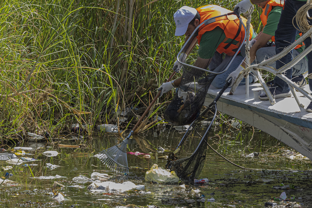 Volunteers in Cairo collect plastic from the Nile as part of a cleanup campaign. (AFP)