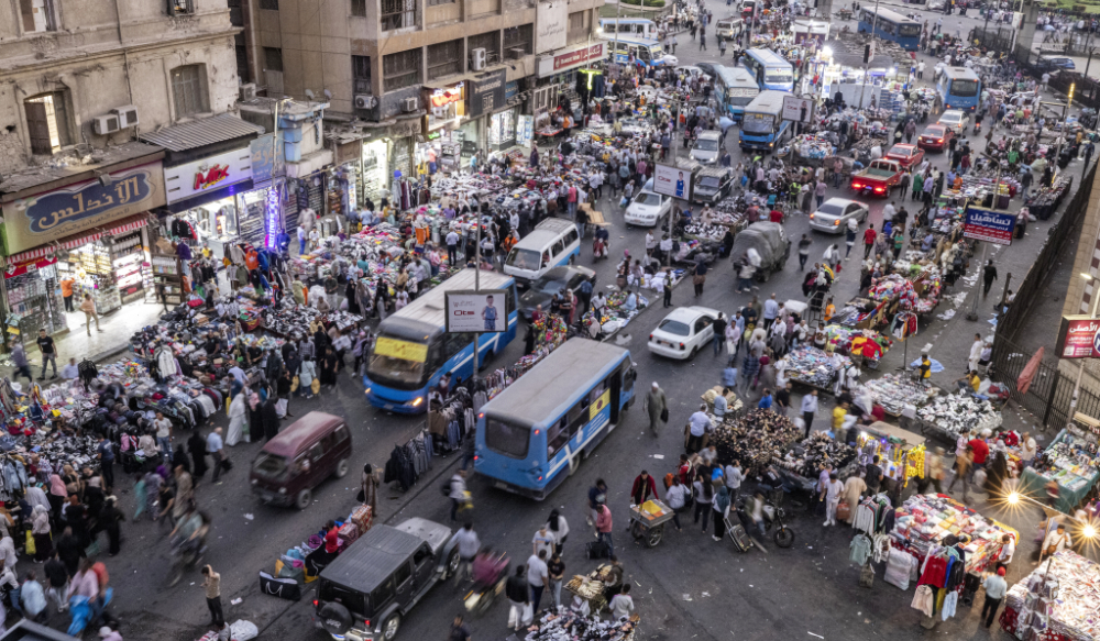 This photo taken on October 24, 2022 shows a view of vehicles and pedestrians at a street market in Attaba Square in the centre of Egypt's capital Cairo. (AFP)