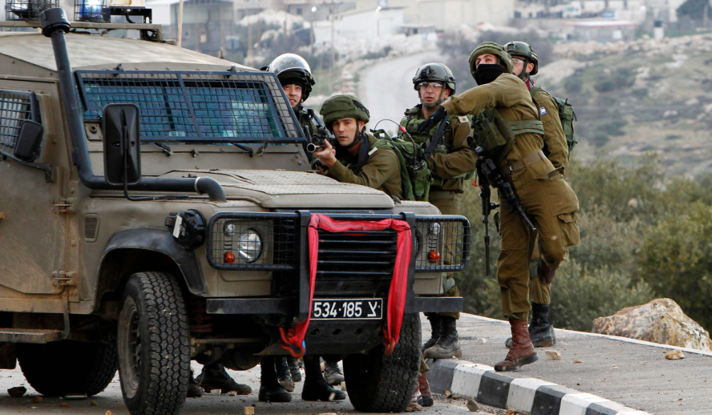 Israeli soldiers clash with Palestinian demonstrators in the West Bank village of Tuqua, south-east of Bethlehem. (AFP)