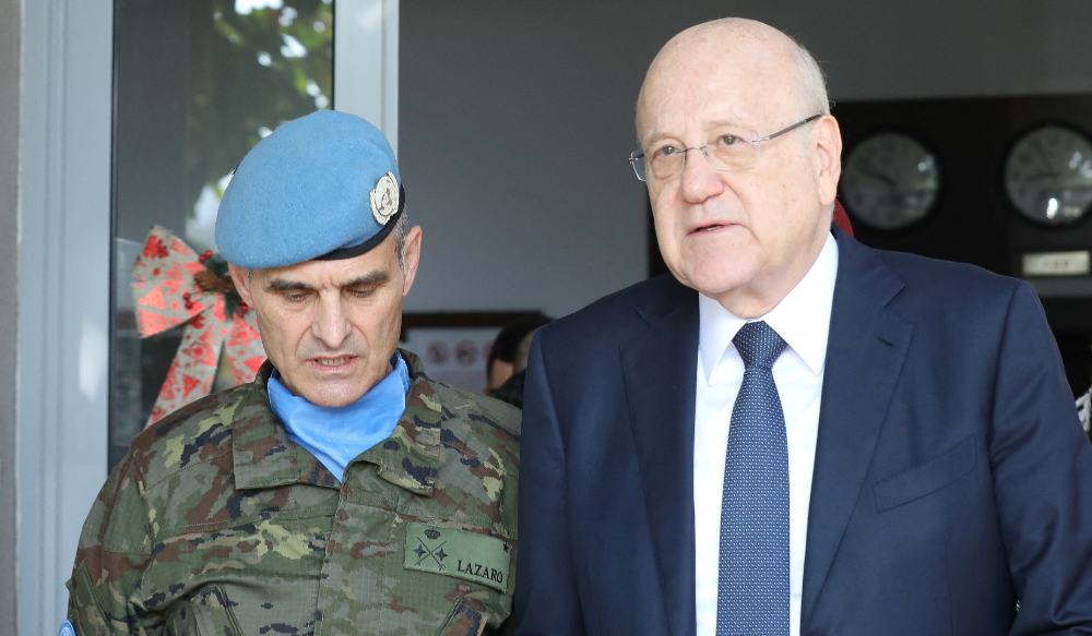 Lebanon's caretaker prime minister Najib Mikati chats with UNIFIL Head of Mission and Force Commander Major General Aroldo Lazaro, during his visit to the headquarters of the United Nations Interim Force in Lebanon (UNIFIL), in Naqoura, Lebanon December 16, 2022. (REUTERS)