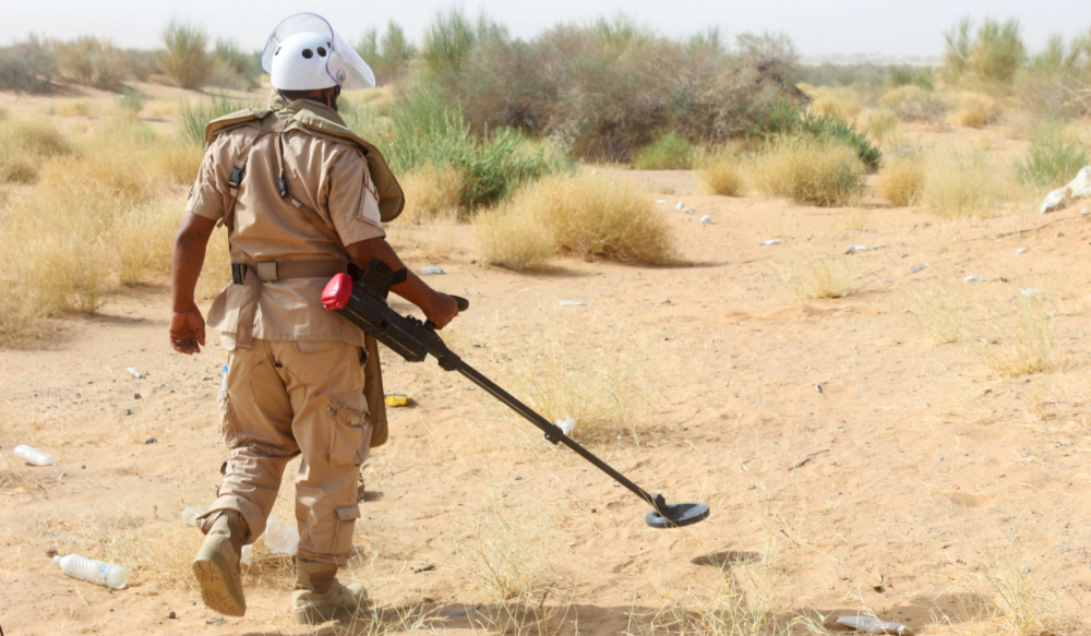 A demining specialist from pro-government forces clears landmines reportedly planted by Houthi rebel forces, from an area on the outskirts of Bayhan town in Yemen's northern Shabwa governorate, on January 19, 2022. (AFP)