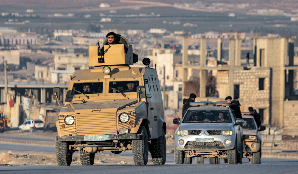 Turkey-backed Syrian fighters deploy in vehicles in al-Bab in the northern rebel-held part of Syria's Aleppo province on January 3, 2023.  (AFP)