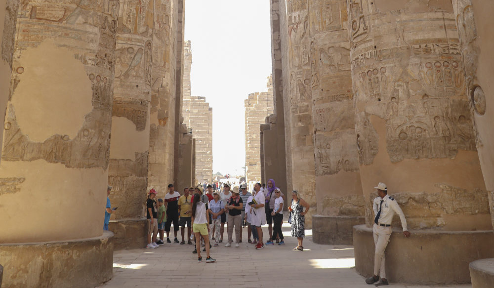 Tourists visit the Karnak Temple on Friday, Nov. 26, 2021, After one day the reopening ceremony of the Avenue of Sphinxes commonly known as El Kebbash Road in Luxor, Egypt.  (AP)