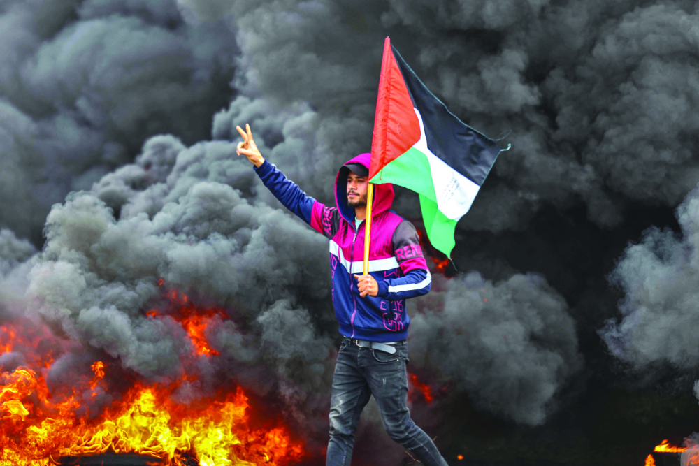 Palestinian youths burnt tires during a recent protest near the Israel-Gaza border, east of Jabalia refugee camp. (AFP)