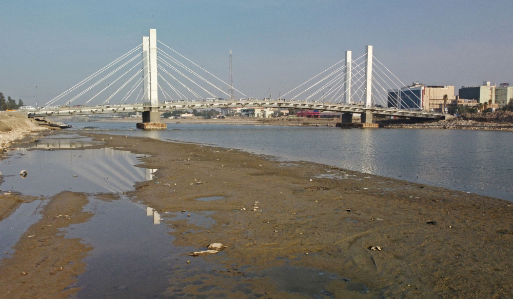 An aerial view shows the Hadarat bridge across the Euphrates river that is witnessing a sharp decrease in water levels, in Nassiriya on February 26, 2023. (AFP)