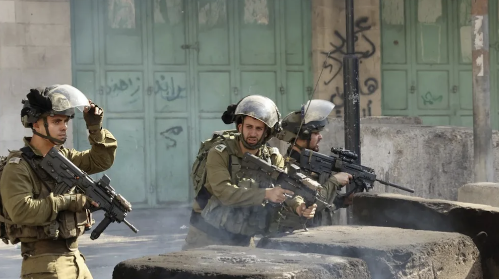 Members of Israeli security forces take position amid clashes with Palestinian protesters in the city center of Hebron in the West Bank. (AFP/File Photo)