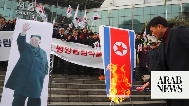 Activists rip North Korean leader's photo in Olympic protest
