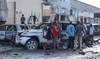 People look at the destruction at a cafe in Mogadishu on July 15, 2024 following a car bomb blast.