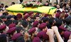 Hezbollah fighters carry the coffin of their top commander Fuad Shuku during his funeral procession in Beirut. 