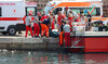 Italian firefighters and health workers carry a body bag with a victim after a sailboat sank off the coast of Porticello.