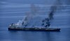 Burning oil tanker drifting but still afloat, British maritime agency says