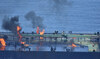 Flames and smoke rise from the Greek-flagged oil tanker Sounion, which has been on fire since August 23, on the Red Sea.