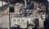 An Israeli armored vehicle drives along a devastated street in Jenin in the occupied West Bank on September 4, 2024.