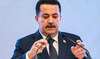 Iraq's Prime Minister Mohammed Shia al-Sudani adjusts his microphones before speaking during an event in Baghdad on May 3, 2024.