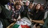 Activists mourn the body of slain Turkish-American activist Aysenur Ezgi Eygi at the Rafidia hospital morgue in Nablus.