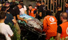 A person is carried on a stretcher outside American University of Beirut Medical Center. (REUTERS)