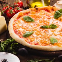 italian pizza Margarita on wood table with ingredients