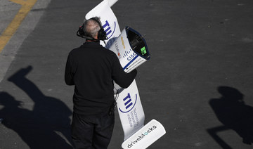 A crew member carries the front nose wing of the KAIST autonomous race car in Las Vegas, Nevada. (AFP)