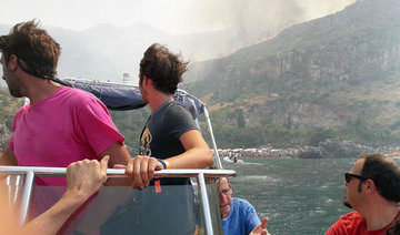 Tourists flee wildfires in Sicily in tense evacuation by sea