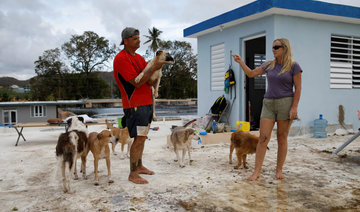 Couple defy Hurricane Maria on roof to save pets — lots of them