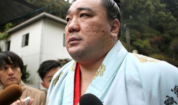 Mongolian sumo champ apologizes after media reports beer bottle assault on fellow wrestler