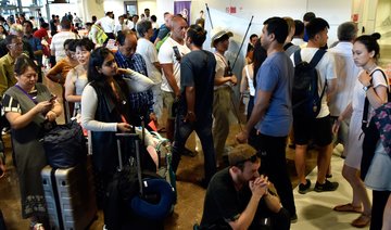 Tourists leave as Bali’s volcano-hit airport gets back to business