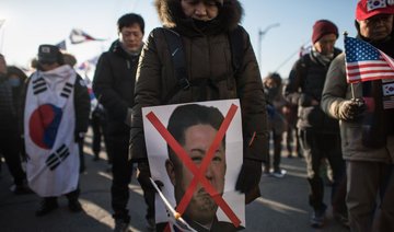 Angry South Koreans protest as ship from North carrying Olympians docks at Donghae City