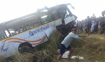 Bus falls into dry river bed in east India, killing 12