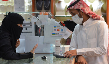 Saudis shop at a jewellery shop in Riyadh after authorities announced an increase in the VAT rate. (AFP)