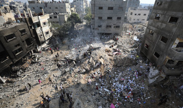 Palestinians look at destruction after an Israeli strike on the Gaza Strip in Nusseirat refugee camp. (AP)