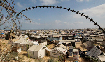 Displaced Palestinians, who fled their houses due to Israeli strikes, shelter at a tent camp, in Rafah. (REUTERS)