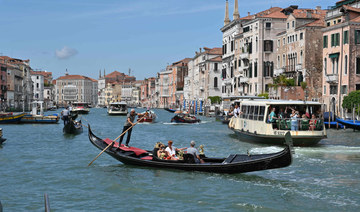 Tourists taking a Gondola ride across the Grand Canal in Venice. (AFP)