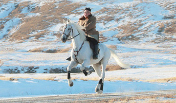 Kim vows to fight US sanctions, visits sacred N. Korean peak