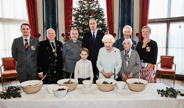 Queen Elizabeth mixes puddings, and sends message of continuity