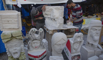 Iraqi artists pay tribute to dead protesters with sculptures