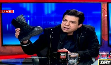 Pakistan bans TV host for not stopping minister’s military boot stunt