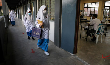 Malaysia will not re-impose coronavirus curbs for now despite spike