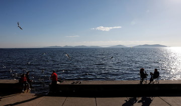 People enjoy a warm and sunny day at the beach amid the spread of the coronavirus disease (COVID-19), in Istanbul, Turkey, December 31, 2020. (Reuters)