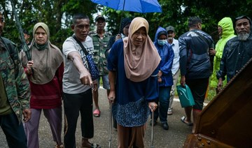 Malaysian villagers escape floods on excavator as 28,000 evacuated