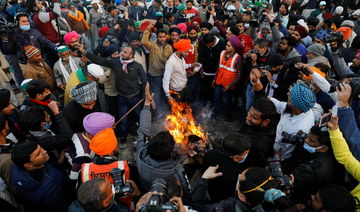 Indian farmers burn legislation in show of defiance